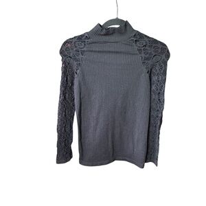 Nikibiki Bodycon Black ribbed mock neck with lace net sleeves .